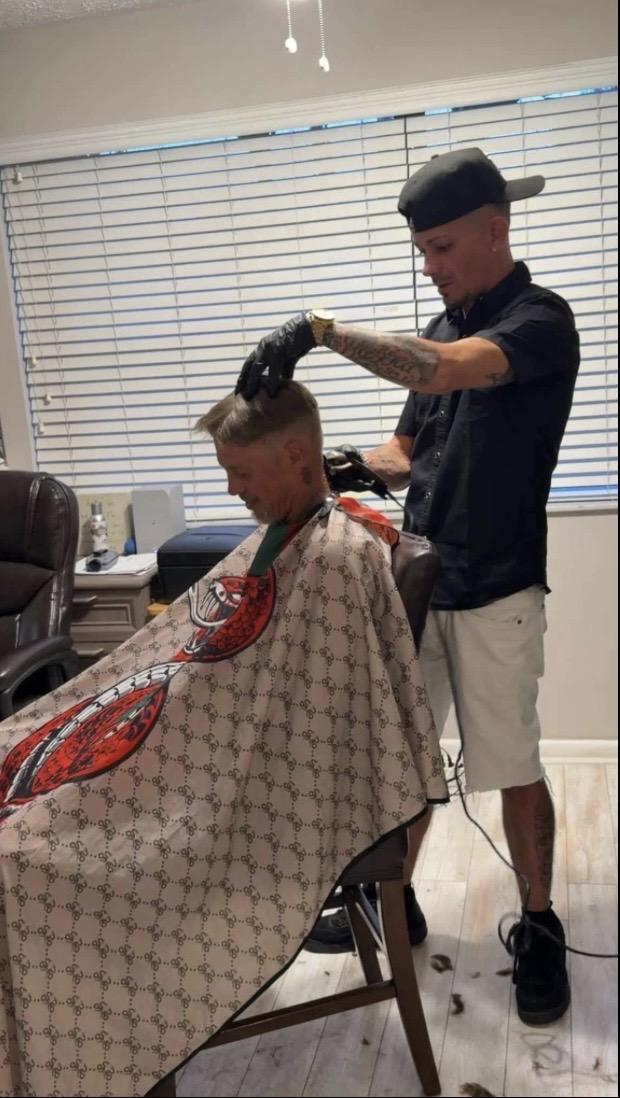 Anthony providing mobile barber service for a client