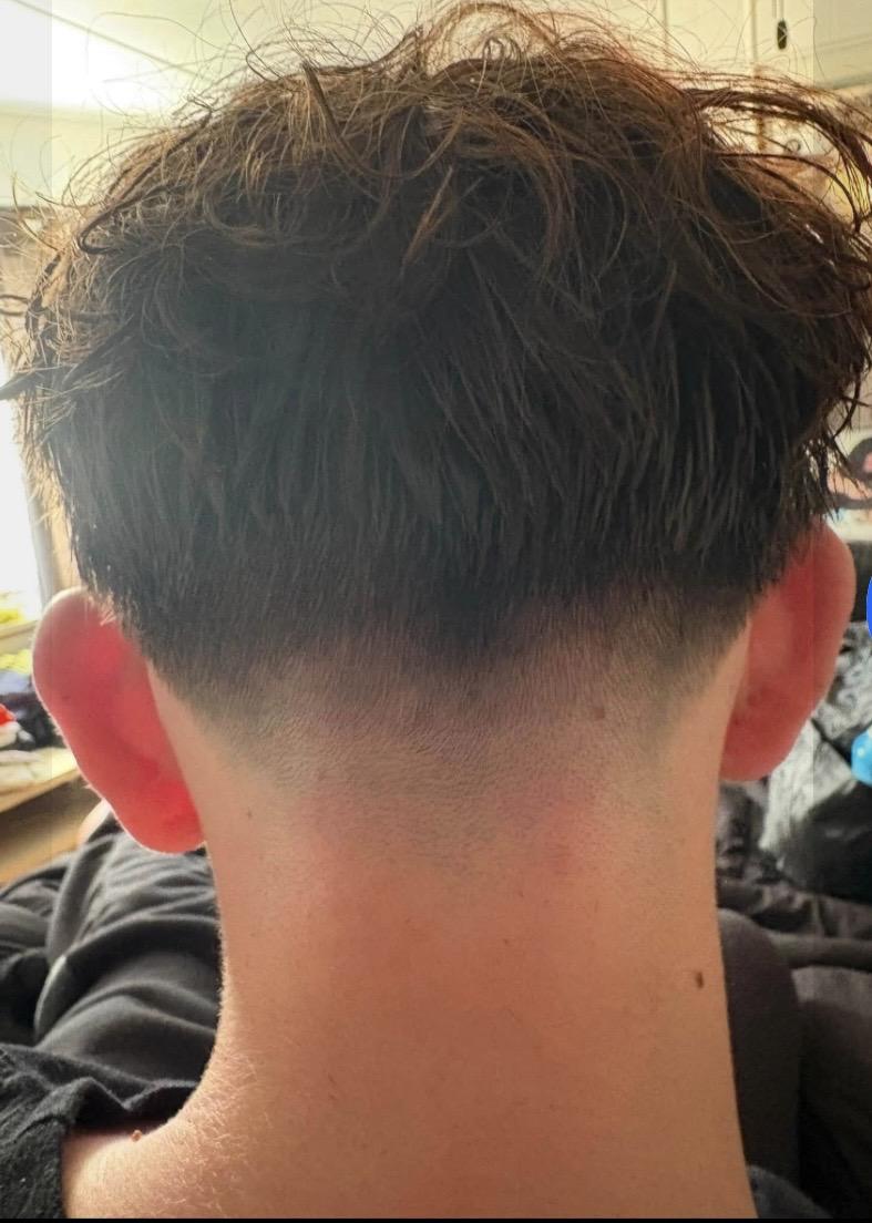 Rear view of textured haircut and tapered neckline